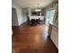 Bright dining space featuring wood floors, kitchen access, and backyard views at 6027 Moonseed Cir, Indianapolis, IN 46203