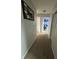 Carpeted hallway leading to bedrooms with stylish decor at 6027 Moonseed Cir, Indianapolis, IN 46203