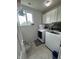 Functional laundry room equipped with modern washer and dryer, and ample storage at 6027 Moonseed Cir, Indianapolis, IN 46203