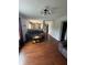 Open-concept living room with wood floors, modern lighting, and view into the kitchen at 6027 Moonseed Cir, Indianapolis, IN 46203