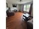 Living room featuring hardwood floors, natural light, and comfortable seating at 6027 Moonseed Cir, Indianapolis, IN 46203