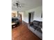 Open-concept living room showing wood floors and seamless flow to the kitchen at 6027 Moonseed Cir, Indianapolis, IN 46203