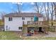 View of the back of the home featuring a raised deck and stairs to the yard at 6120 E Southport Rd, Indianapolis, IN 46237