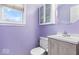 Compact bathroom featuring a toilet, single sink vanity, and built in storage cabinet at 6120 E Southport Rd, Indianapolis, IN 46237