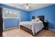 Bedroom features hardwood flooring, a window with natural light, and a modern decor at 6120 E Southport Rd, Indianapolis, IN 46237