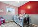 Bedroom with multi-tone walls, hardwood flooring, a window and vanity at 6120 E Southport Rd, Indianapolis, IN 46237
