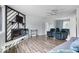 Open concept living area showcasing wood floors, a modern ceiling fan, and a comfortable seating arrangement at 6120 E Southport Rd, Indianapolis, IN 46237