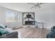 Living area featuring wood floors, a modern ceiling fan, and a decorative fireplace with a TV above at 6120 E Southport Rd, Indianapolis, IN 46237