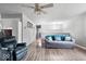 Open concept living area showcasing wood floors, a modern ceiling fan, and a comfortable seating arrangement at 6120 E Southport Rd, Indianapolis, IN 46237
