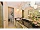 Well-lit bathroom with a long vanity and decorative wallpaper at 6851 Azalea Dr, Indianapolis, IN 46214