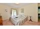 Charming bedroom with a floral comforter and a view from the window at 6851 Azalea Dr, Indianapolis, IN 46214