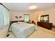 Bedroom with a king-sized bed, wood furniture, and bright windows at 6851 Azalea Dr, Indianapolis, IN 46214