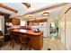 Open kitchen features wood cabinets, laminate countertops, and bar seating with bright lighting at 6851 Azalea Dr, Indianapolis, IN 46214