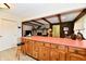 Spacious kitchen with an orange countertop and view to the living area with wood paneling at 6851 Azalea Dr, Indianapolis, IN 46214