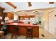 Bright kitchen with wood cabinets, laminate countertops, and breakfast bar with seating at 6851 Azalea Dr, Indianapolis, IN 46214