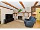 Inviting living room features brick fireplace with wooden beams and comfortable seating at 6851 Azalea Dr, Indianapolis, IN 46214