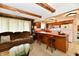 Open-concept living area flows into kitchen with bar seating and bright countertops at 6851 Azalea Dr, Indianapolis, IN 46214