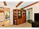 Open living area features wood beams, built in bookcase and views into adjoining dining room at 6851 Azalea Dr, Indianapolis, IN 46214
