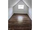 Small attic space featuring wood-look flooring and natural light at 7831 E 46Th St, Indianapolis, IN 46226