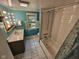 Bright bathroom featuring a vanity, toilet, and combined shower and bathtub under a window, providing natural light at 7831 E 46Th St, Indianapolis, IN 46226