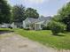 Charming home featuring a spacious front yard and white exterior with a cozy porch at 7831 E 46Th St, Indianapolis, IN 46226