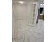 Bright hallway features marble-patterned tile floor and a door leading to the kitchen at 7831 E 46Th St, Indianapolis, IN 46226