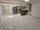 Open-concept area combining the kitchen, which includes stainless steel appliances, with the living space with marble flooring at 7831 E 46Th St, Indianapolis, IN 46226