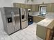Updated kitchen featuring stainless steel refrigerators and marble countertops and floors, creating a modern and functional space at 7831 E 46Th St, Indianapolis, IN 46226