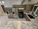 Well-equipped kitchen area showcasing stainless steel refrigerators, range, and marble countertops and floors at 7831 E 46Th St, Indianapolis, IN 46226