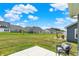 Spacious backyard includes a patio with a comfortable chair and offers views of nearby homes and the surrounding neighborhood at 843 Garrow Dr, Westfield, IN 46074