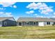 View of the home's backyard showing the lawn, patio with seating, exterior siding, and the surrounding community at 843 Garrow Dr, Westfield, IN 46074