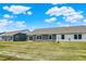 Landscaped backyard featuring a well-maintained lawn, patio, and neighboring houses under a bright blue sky at 843 Garrow Dr, Westfield, IN 46074