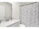Modern bathroom featuring a white vanity, toilet, and shower with a floral curtain at 843 Garrow Dr, Westfield, IN 46074
