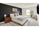 Modern bedroom featuring a dark accent wall, plush bedding, and neutral decor with carpet flooring at 843 Garrow Dr, Westfield, IN 46074