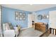 Bedroom with blue walls, crib, white chair, dresser and art on the walls at 843 Garrow Dr, Westfield, IN 46074