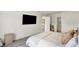 Bright bedroom with a king size bed, gray carpet, TV and open door to closet and bathroom at 843 Garrow Dr, Westfield, IN 46074