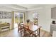 Bright dining area with a wooden table, seating for eight, and a view of the backyard at 843 Garrow Dr, Westfield, IN 46074