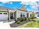 Charming home entrance with a black front door, detailed trim, and beautiful landscaping at 843 Garrow Dr, Westfield, IN 46074