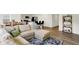 Open-concept living area featuring a plush sectional, wood flooring, and modern decor at 843 Garrow Dr, Westfield, IN 46074
