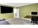 Home office featuring green walls, desk and chair, a TV, window and doorway to another room at 843 Garrow Dr, Westfield, IN 46074