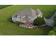 Aerial view of house with deck, gazebo and outdoor kitchen surrounded by a large, green manicured lawn at 8785 W 100 N, Anderson, IN 46011