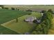 Aerial view showcasing the backyard deck, lush greenery, and rural surroundings of this beautiful home at 8785 W 100 N, Anderson, IN 46011