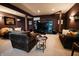 Basement designed as a home theater featuring a large TV, comfortable seating, and dark walls at 8785 W 100 N, Anderson, IN 46011