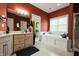 Bright primary bathroom boasts a soaking tub, separate shower, and dual sink vanity at 8785 W 100 N, Anderson, IN 46011
