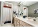 Bathroom featuring double sinks, a large mirror, and a shower with a white curtain at 8785 W 100 N, Anderson, IN 46011