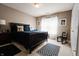 Well-lit bedroom showcasing a wooden bed frame, complementary furniture, and patterned rug at 8785 W 100 N, Anderson, IN 46011