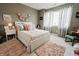Charming bedroom with a white bed frame, light gray walls, and window with gray and white curtains at 8785 W 100 N, Anderson, IN 46011