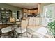 Bright dining area with glass table and chairs adjacent to the kitchen at 8785 W 100 N, Anderson, IN 46011