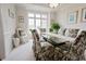 Bright dining room with a glass table, floral chairs, and large windows at 8785 W 100 N, Anderson, IN 46011