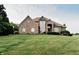 Charming brick home featuring a well-manicured lawn and beautiful landscaping, enhancing its curb appeal at 8785 W 100 N, Anderson, IN 46011